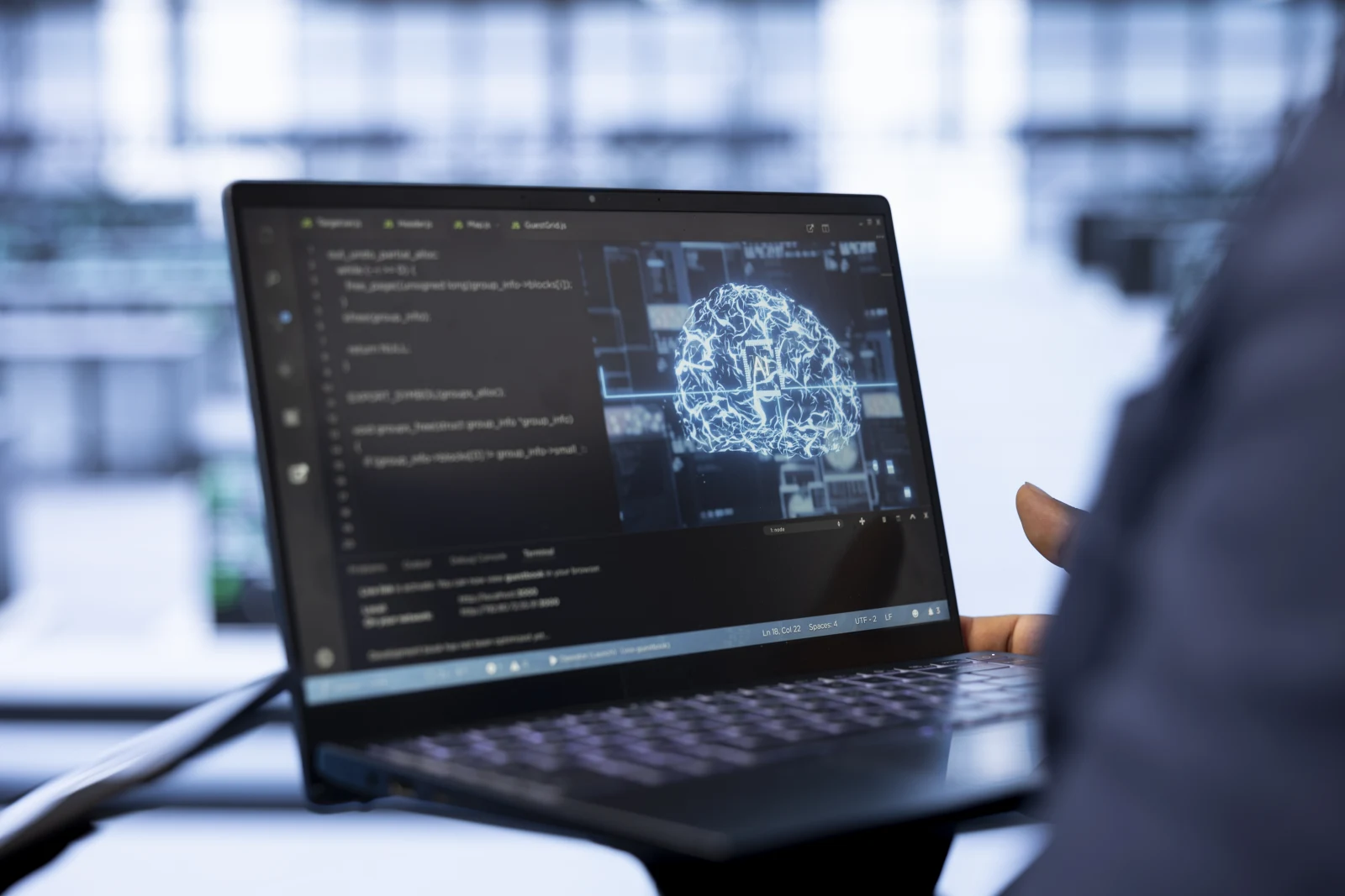 System administrator using laptop data center updating ai systems