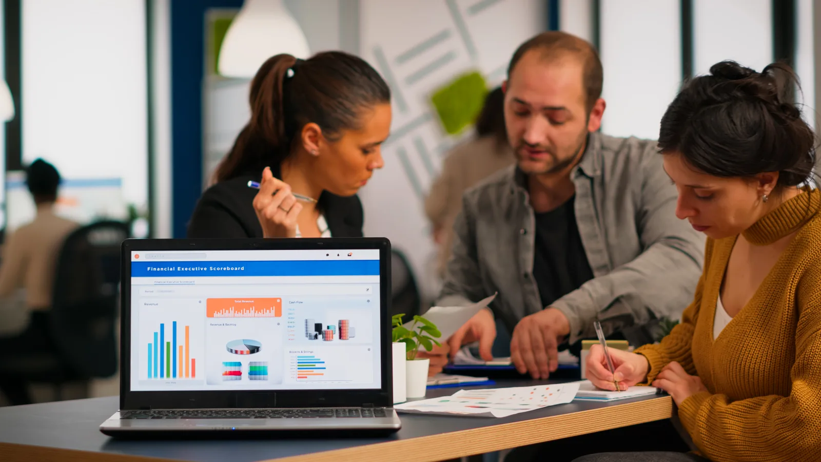 Business woman talking about financial project taking notes discussing start up ideas using laptop diverse employees gathered co working working process busy company teamwork help
