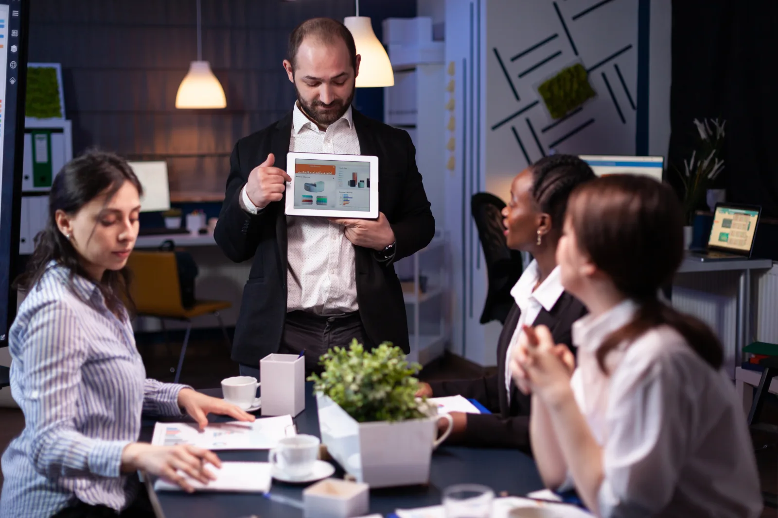 Focused businessman showing corporate graphs presentation using tablet working company ideas